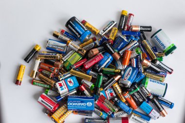 Color batteries of different sizes on a white background isolate clipart