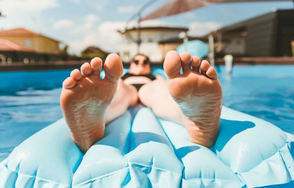 Jovem mulher na piscina colchão de ar na piscina acima do solo. — Fotografia de Stock