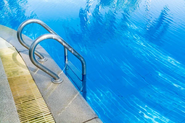 swimming pool bar ladder in light blue water
