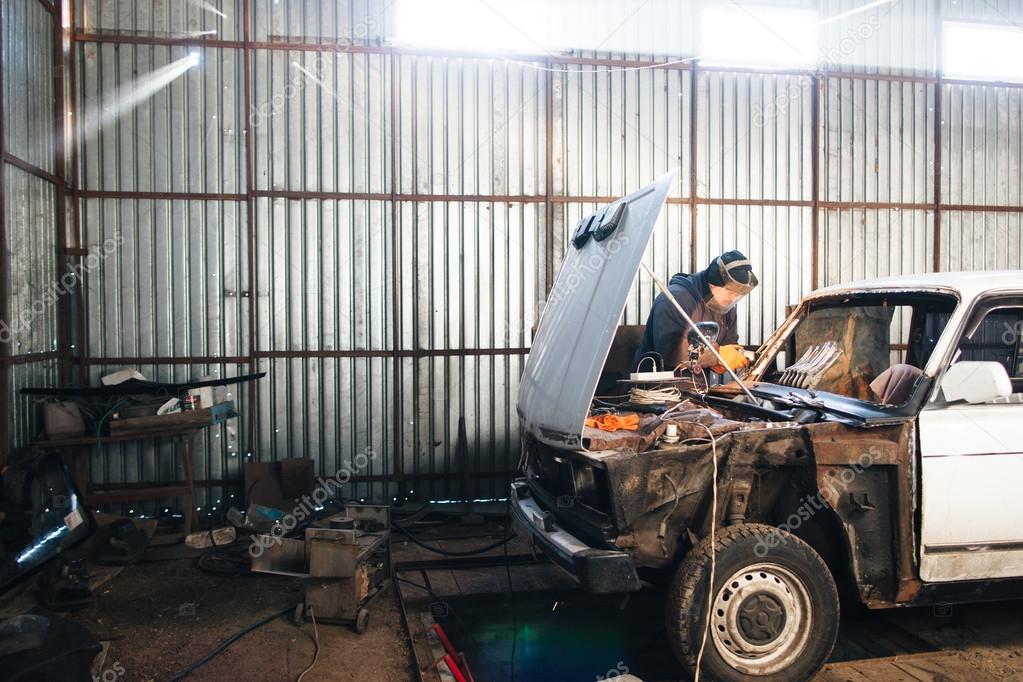 Mechanic repair and service car in garage