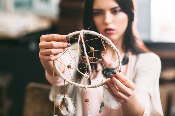 Master looks at the finished Dreamcatcher.