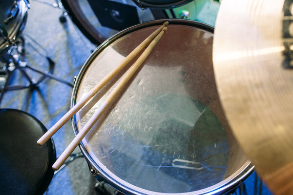 Drum set and drumsticks. Top view