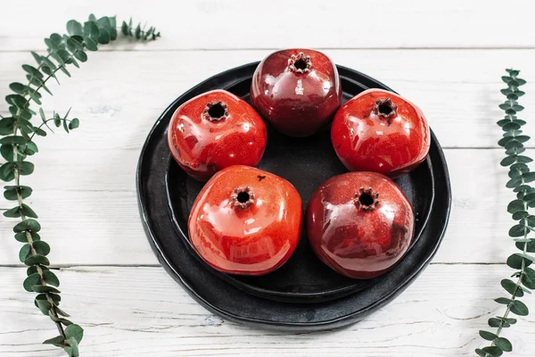 Ceramic red pomegranates on white background — Stock Photo, Image