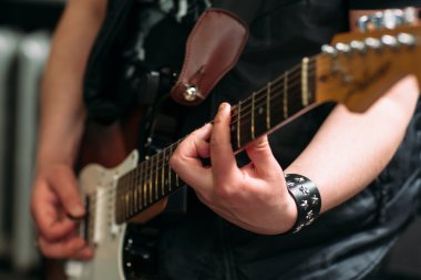 Musician playing six string electric guitar