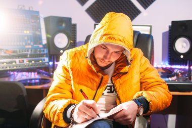 DJ writes new lyrics in recording studio clipart