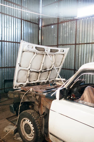 Disassembled old car in garage close-up