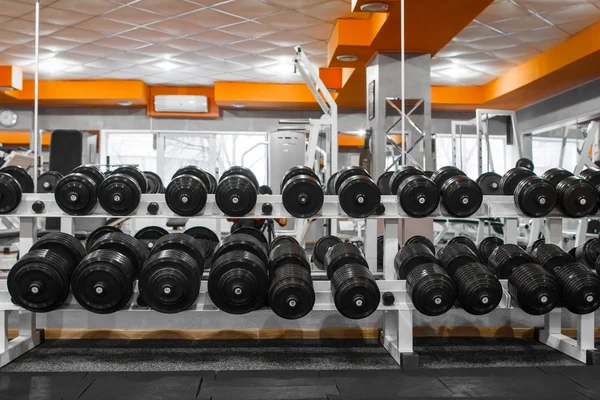 Dumbbells rack at gym interior front view — Stock Photo, Image