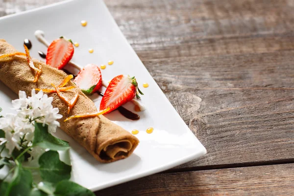 Crepe with strawberry on white plate copyspace — Stok Foto