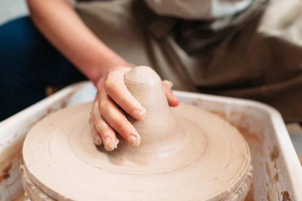 Hand of potter on clay at workplace — Stock Photo, Image