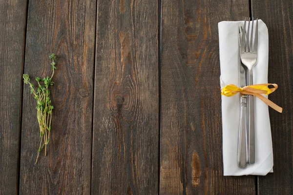 Cutlery and rosemary on dark wood copyspace — Stok Foto