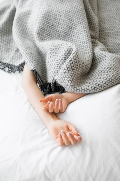 Fully covered woman except hands in bed — Stock Photo, Image