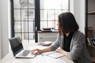 Dizüstü ekran bakarak sıkılmış ofis çalışanı