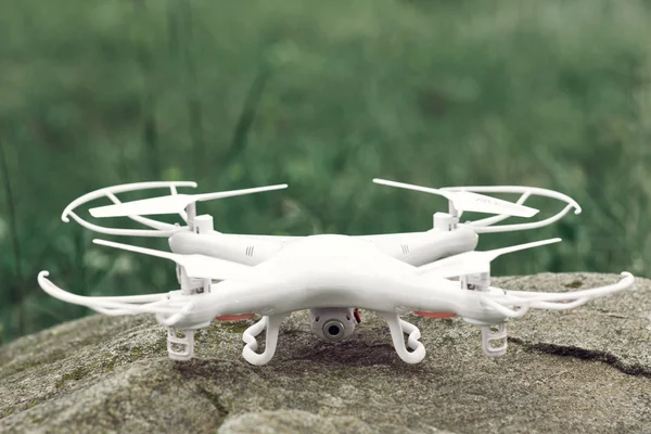 White quadrocopter on stone, drone, close-up