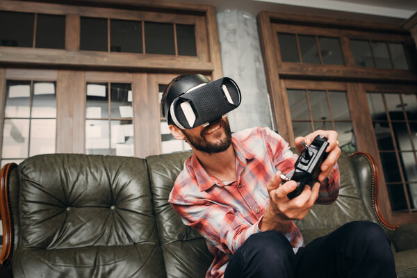 Man playing video games in virtual reality headset Stock Picture