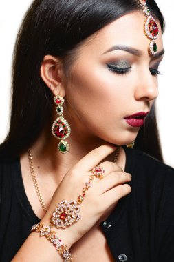 Gorgeous woman with luxurious jewelry close-up clipart