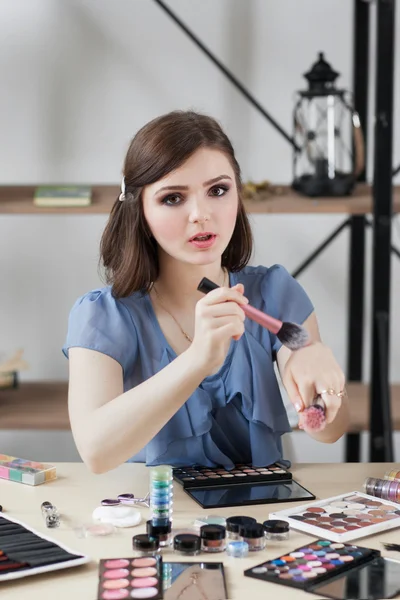 Proffesional makeup artist testing brush softness