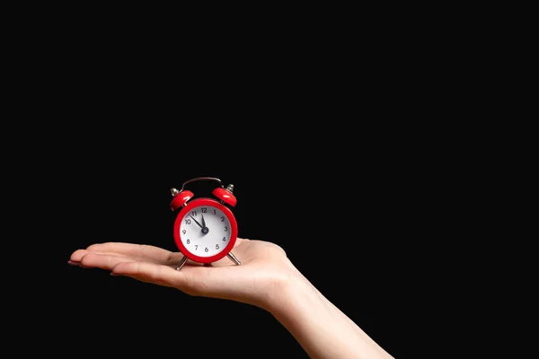 Time management hand vintage red alarm clock black — Stock Photo, Image