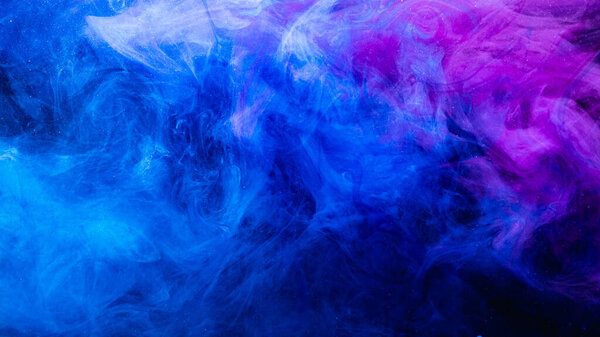 Color in water. Art background. Fluorescent glowing steam texture. Bright ultraviolet blue purple glitter smoke cloud blend on dark.