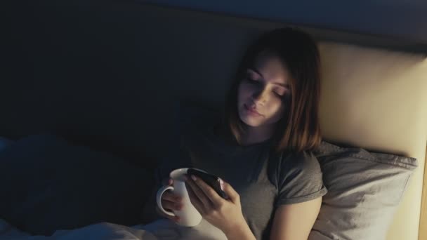 Noite online móvel lazer mulher telefone cama chá — Vídeo de Stock