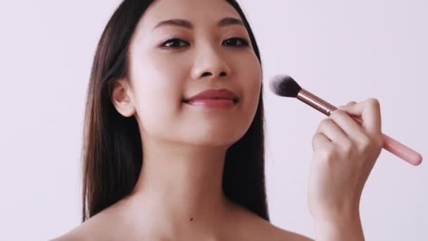 Japanese makeup beauty care woman using face brush — Stock Video