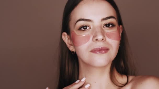 Facial skincare female face with pink eye patches — Stock Video