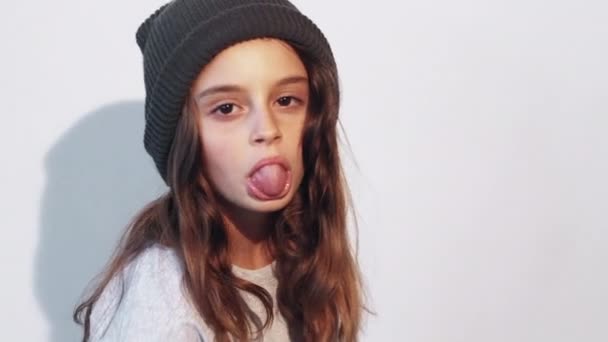 Naughty child mischievous girl sticking tongue out — Stock Video