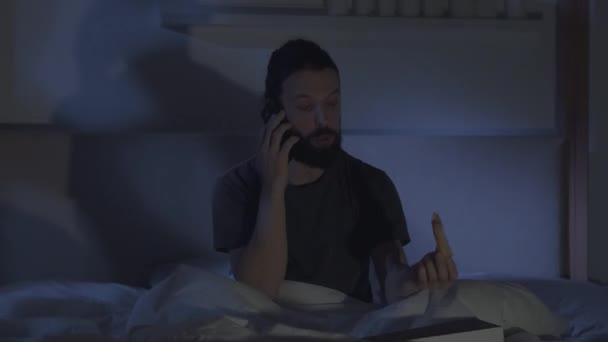 Night home leisure man on phone watching tv in bed — Stock Video