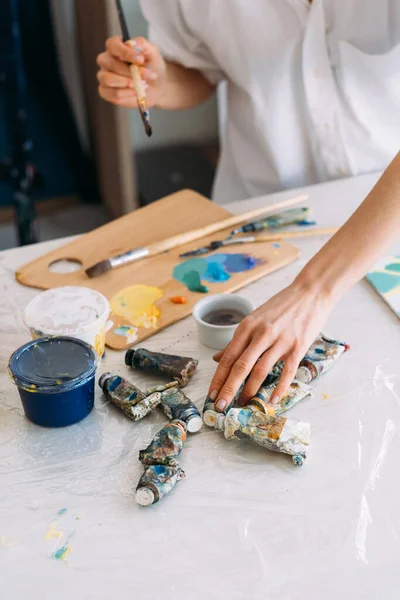 Artist workplace painting art hands with oil paint — Stock Photo, Image