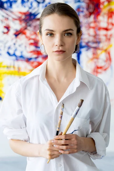 artist portrait art class woman with paintbrushes