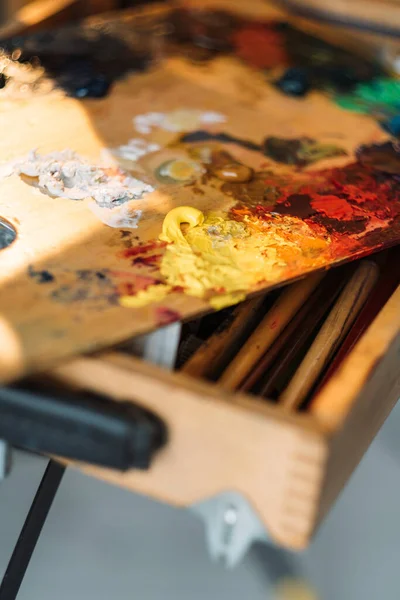 artist mess painting tools oil paint on palette