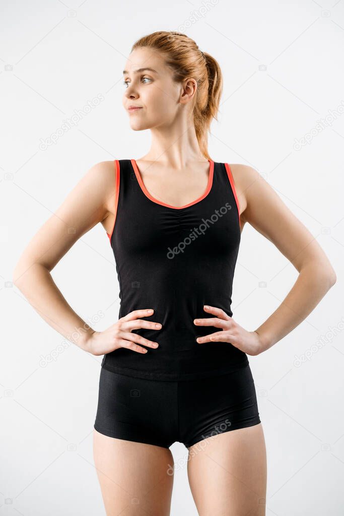 Woman activewear. Outfit template. Sports apparel fashion. Fitness apparel. Front view of female athlete model with slim body in logo mockup black tank top shorts isolated on light.