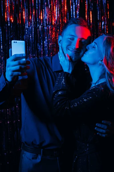 Navidad selfie gadget gente neón pareja teléfono —  Fotos de Stock