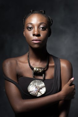 confident African woman with an ethnic  necklace