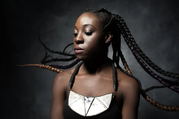 Black woman with the flying braided long hair — Stockfoto