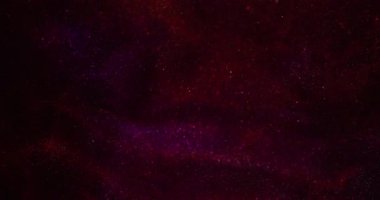 Bokeh parıltısı. Parıltılı soyutlama. Mor kırmızı renkli aydınlık parıltı ışıltılı parlak doku sanatın koyu siyah zemininde yüzüyor..