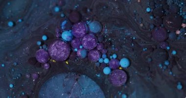 Bubbles blend. Sparkling paint. Defocused purple blue yellow color glitter oil acrylic water round fluid circle on abstract background.