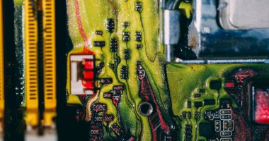 Ink spill. Processor chip. Defocused yellow blue red color digital motherboard acrylic glitter liquid on abstract electronic background.