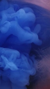 Dikey video. Ruhsal buhar. Arkaplanı boya. Odaklanmamış mavi turuncu renk sis deseni soyut koyu siyah sanat üzerine kimyasal sis suyu.