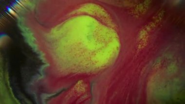 Parlak mürekkep. Bulanık parıltı sıvısı. Odaklanamayan sarı mavi renkli parlak su soyut koyu siyah arkaplan üzerine dökülüyor..