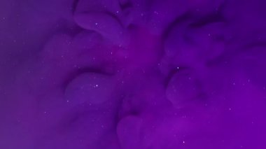 Boya dumanı. Sıvı sıçraması. Odaklanmamış mor neon rengi ışıl ışıl ışıl parıldayan nemli doku soyut pembe arka planda yüzüyor..