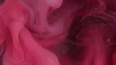 Duman yüzüyor. Mürekkep karışımı. Odaklanmamış pembe ışıldayan parçacıklar buhar dalgası akışı soyut sanat arkaplanını harmanlıyor.