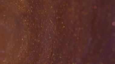 Mürekkep fırıldağı. Akrilik girdap dokusu. Odaklanmamış sarı mor renk simleri soyut yaratıcı sanat arka planında akıyor..