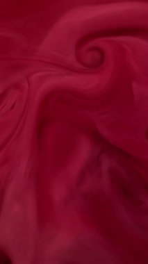 Dikey video. Bulut dalgası. Boya karışımı. Odaklanmamış kırmızı kırmızı su dokusu kimyasal sis akrilik sıvı soyut sanat arka planına yayılıyor.