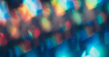 Blur lens leak. Flare blend. Rainbow bright light mix color. Faceted prism shimmering reflection texture abstract dark background.