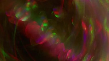 Blur crystal glow. Dazzle neon bokeh. Pink purple green color illuminated radiant lens flare glitter circle on abstract dark black visual background.