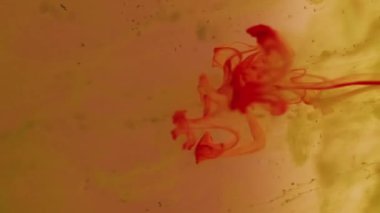 Boya çözeltisi. Duman girdabı. Pembe turuncu pigmentler damlayan su bulanıklığı karışımı. Sanat parçacıkları soyut sıvı arkaplan lekesi boyar.