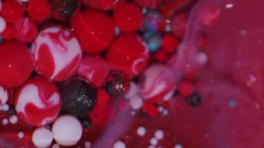 Mürekkep dök. Boya sıvısı. Bulanık, kırmızı, mavi, parlak, mor renk, yağ damlacıkları soyut sanat arka planında yüzer..