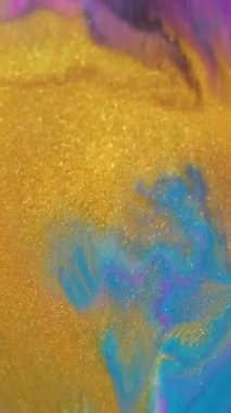 Dikey video. Parıldayan sıvı. Odaklanmamış mürekkep girdabı. Altın mavisi mor parıldayan akrilik emülsiyon kürenin soyut arka planında renk akışını karıştırıyor.