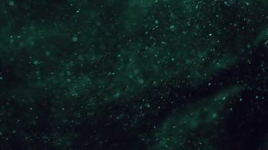 Bokeh ışığı. Parlak doku. Doğal yeşil renk aydınlatmalı parıltılı parıltılı sanat soyut parlak siyah arka planda yüzüyor..