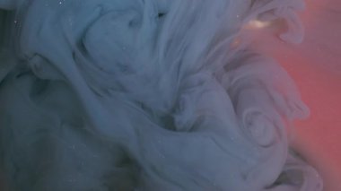 Kıvrımlı ışıldayan boya. Buhar sanatı. Soyut arkaplanda bulanık mavi pembe mürekkep simli akrilik kimyasal ışıl ışıl madde.